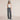 Charcoal gray high waist wide-leg trousers for women, showcasing a fashionable design and paired with a sleeveless shirt.