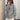 Chunky oversized gray turtleneck wool sweater in XL, featuring warm ribbed knit texture with long sleeves and a high collar, worn by a person standing in front of a mirror.