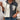 Women's color-block button-up hoodie in casual autumn fashion, featuring white and black sections, with a focus on the shoulder, arm, and neck areas.