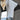 Women's color-blocked sweater in a casual fall fashion style, featuring a soft knit fabric with a mix of white and complementary colors. The sweater has a round neck and is styled with long sleeves, ideal for layering during cooler weather.