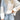 Women's color-blocked sweater featuring a white and black design, showcasing long sleeves and a round neck, ideal for casual fall fashion.