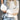 Women's color-blocked sweater styled for casual fall fashion, featuring a chic design with various color panels, worn by a model with a hat, showcasing the sweater's fit and fashionable appeal for the autumn season.