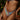 Woman wearing a colorful bohemian paisley print bikini with a halter swimsuit top and matching bottom, standing in an outdoor setting.