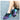 Colorful women's running shoes featuring a lightweight and breathable design in shades of azure, purple, and pink, shown on a person's legs.