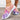 Colorful women's slip-on walking sneakers with a rainbow mesh design, featuring a lightweight build, predominantly in shades of purple, pink, and violet.
