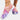 Colorful women's slip-on walking sneakers featuring a rainbow mesh design with shades of purple, pink, and violet, displayed on a person's foot.
