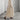 Eco-friendly oatmeal linen maxi dress with a minimalist loose fit, featuring long sleeves and a flowing silhouette. The dress is displayed in an indoor setting, showcasing its elegant simplicity and natural texture.