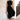Elegant black midi dress with a back cutout, featuring a fitted waist and knee-length hem. The dress has a stylish one-piece design suitable for evening wear.