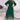 Elegant satin emerald green V-neck midi dress with belted waist, featuring short sleeves and knee-length hem, perfect for day or evening wear.