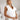 Elegant white sleeveless V-neck belted formal jumpsuit for women.