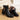 Elegant women's black leather ankle boots featuring a chic winter style, showcasing a sleek design with a durable synthetic rubber sole and stylish fashion elements.