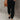 Fashionable Women's chambray pants featuring lightweight fabric, an elastic waist, and a casual linen texture, modeled with visible grey tone and paired with accessories like shoes and a bag.