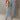 Fashionable women's chambray pants, lightweight with elastic waist, shown on model wearing a grey dress shirt, highlighting leg, joint, and waist areas.