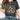 Women's charcoal gray floral graphic tee with wildflower print, styled with jeans, showcasing shoulder and arm detail.