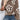 Women's white fluffy sweater with a floral pattern, featuring a V-neck design, long sleeves, and a chic and trendy style. The sweater is paired with jeans, showcasing a stylish and casual look.