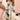 Women's floral silk blouse with designer patterns, featuring a white base color, dress shirt style with a collar, long sleeves, and a fitted waist, showcasing elegant fashion.