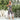 Women's floral strappy jumpsuit worn outdoors, showcasing a bohemian summer style with a focus on the waist and thigh areas, accessorized with eyewear.