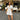 Floral white puff sleeve V-neck short summer dress worn by a woman standing and smiling, highlighting the dress's elegant one-piece design with emphasis on the sleeves and waist.