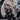 Furry gray oversized women's winter jacket with a chic street style, featuring a textured fur material, long sleeves, and paired with jeans.