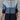Gradient blue women's zip-front ribbed knit ombre sweater displayed on a mannequin, featuring long sleeves and a stylish ombre design.