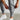 Men wearing gray tapered joggers paired with casual white shoes, showcasing a relaxed athletic style.