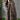 A woman wearing a green ribbed sweater paired with a floral maxi skirt, showcasing a stylish fall fashion ensemble.