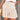 Woman wearing a green smocked summer skirt with an elastic waist and ruffles.