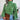 Green women's chunky cable knit high-neck wool sweater with long sleeves and textured design.