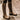 Insulated waterproof leather riding boots designed for winter equestrian activities, featuring knee-high coverage and durable leather construction.