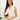 Ivory backless maxi dress with crossover straps and pockets, perfect for bridesmaids, featuring elegant bridal clothing design with floral accents.