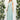 Ivory backless crossover strap bridesmaid maxi dress with pockets, featuring a flowing silhouette. The dress is displayed on a model with long hair, revealing the elegant backless design and crossover straps.