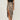 Leopard print high-waist midi skirt on a model, showcasing trendy women's fashion with a sophisticated animal print design. The skirt is styled as part of a fashionable outfit, highlighting its fit around the waist and its flowy midi length.