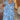 Light blue floral V-neck maxi dress with a side split, featuring short sleeves and a fitted waist, suitable for summer wear.