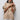 Light blue turtleneck poncho sweater featuring an oversized collar, styled in an elegant beige color, designed for an XXL fit. The sweater showcases a chic loose fit with long sleeves and a sophisticated wrap style around the shoulders and neck, accentuating the wearer's waist.