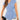 Light blue V-neck twist-front blouse for women with short sleeves, modeled on a person.