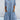 Light blue women's denim shirt dress with lace trim, featuring pockets, a dress shirt style collar, and short sleeves.