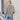 Light brown women's casual knit sweater with a relaxed fit and ribbed texture, featuring long sleeves and a round neckline.