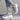 Light grey women's fashion sneakers featuring breathable mesh and a cushioned sole, displayed against a neutral background.
