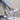 Light grey women's fashion sneakers with breathable mesh and cushioned sole, designed for walking and casual wear.