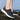 Lightweight breathable slip-on women's sneakers with a water-resistant design in a grey color, suitable for walking and casual sportswear activities.