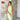 Elegant lime green backless halter maxi dress worn by a smiling woman, highlighting fashion design elements such as a halter neckline, fitted waist, and flowing skirt reaching the thighs and knees.