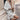 White linen shirt for women designed as a casual summer blouse, featuring lightweight fabric ideal for beach wear. The shirt includes shoulder-length sleeves and a comfortable fit around the waist, shown on a standing model.