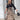 Long paisley skirt paired with a black blouse, showcasing chic women's office wear, featuring stylish fashion elements like a fitted waist, elegant sleeves, and a sophisticated neckline.