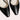 Black low-heel flats made of leather for women, featuring a minimalist design focused on comfort.