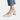 Women's low-heel black flats made of leather, worn with jeans, showing a comfortable fit suitable for a minimalist style.