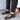 Luxury black leather men's formal shoes featuring a designer checkered pattern, showcasing elegant fashion with a sleek, polished finish.