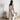 Luxury designer two-tone women's tote bag displayed on a wooden floor, showcasing its elegant design and fashionable appeal.