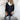 Luxury white wool cape for women's winter fashion, featuring a high collar, long sleeves, and elegant design details for a sophisticated look.