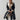 Luxury women's black leather coat with shearling lining, featuring a classic overcoat design with a notched collar, tailored waist, full-length sleeves, and knee-length hem.