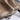Luxury women's tan suede faux fur winter jacket with a soft beige color, featuring a cozy faux fur collar and long sleeves, made from high-quality textile material.
